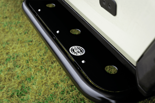 Close-up view of a DMW rock slider step plate for the Ineos Grenadier, showcasing precision-cut holes and the engraved DMW logo on a sleek black powder-coated surface. Designed for superior grip and durability, this step plate is fitted to the INEOS Grenadier.