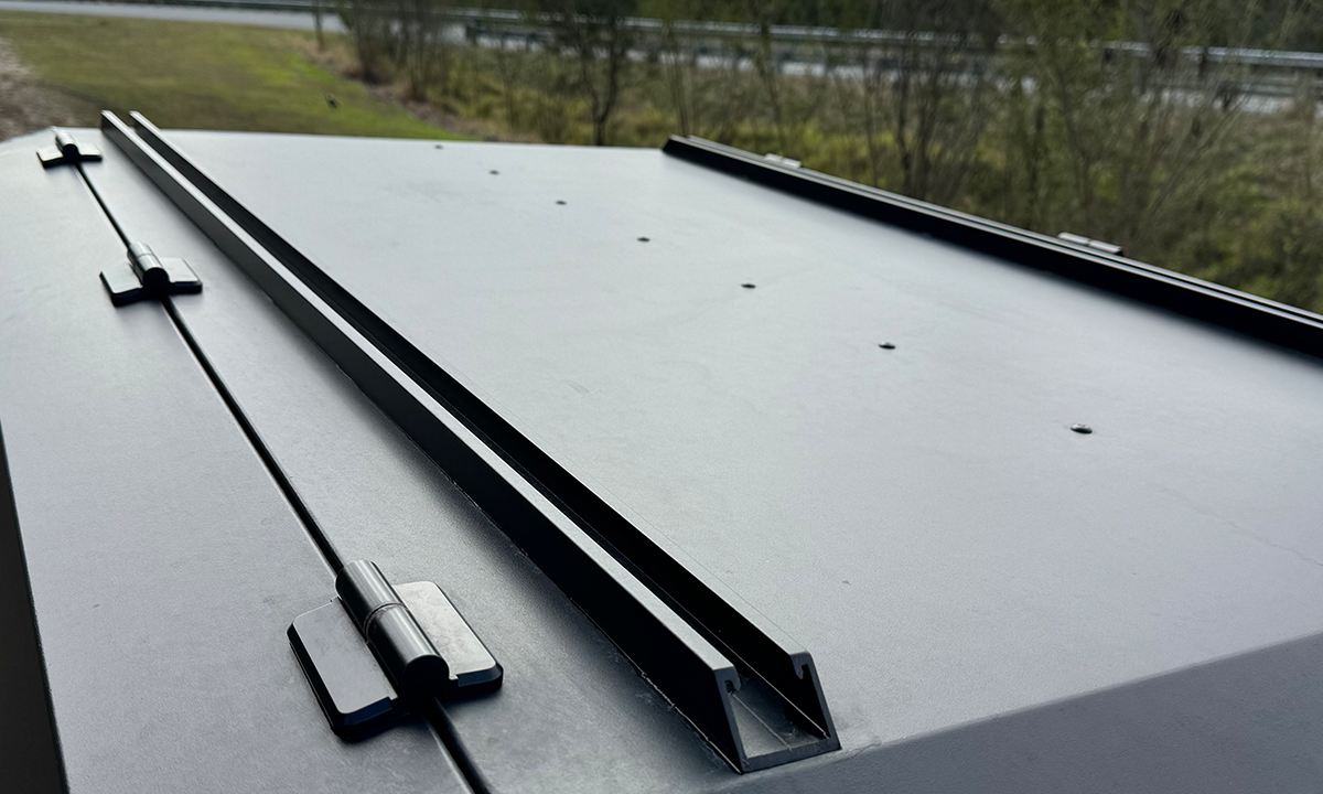 Detailed top view of a DMW canopy roof showing integrated mounting tracks and hinge hardware, designed for easy installation of roof racks, rooftop tents, or solar panels. The low-profile alloy rail system ensures strength and modular compatibility without compromising canopy structure.