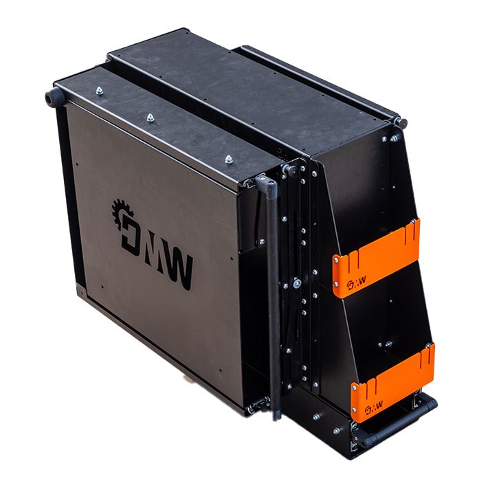 Load image into Gallery viewer, Angled top-down view of the DMW Compact Kitchen and Pantry in its fully closed position. The unit is compact and robust, with laser-cut DMW branding and signature orange brackets visible, ready for mounting inside a canopy or service body.
