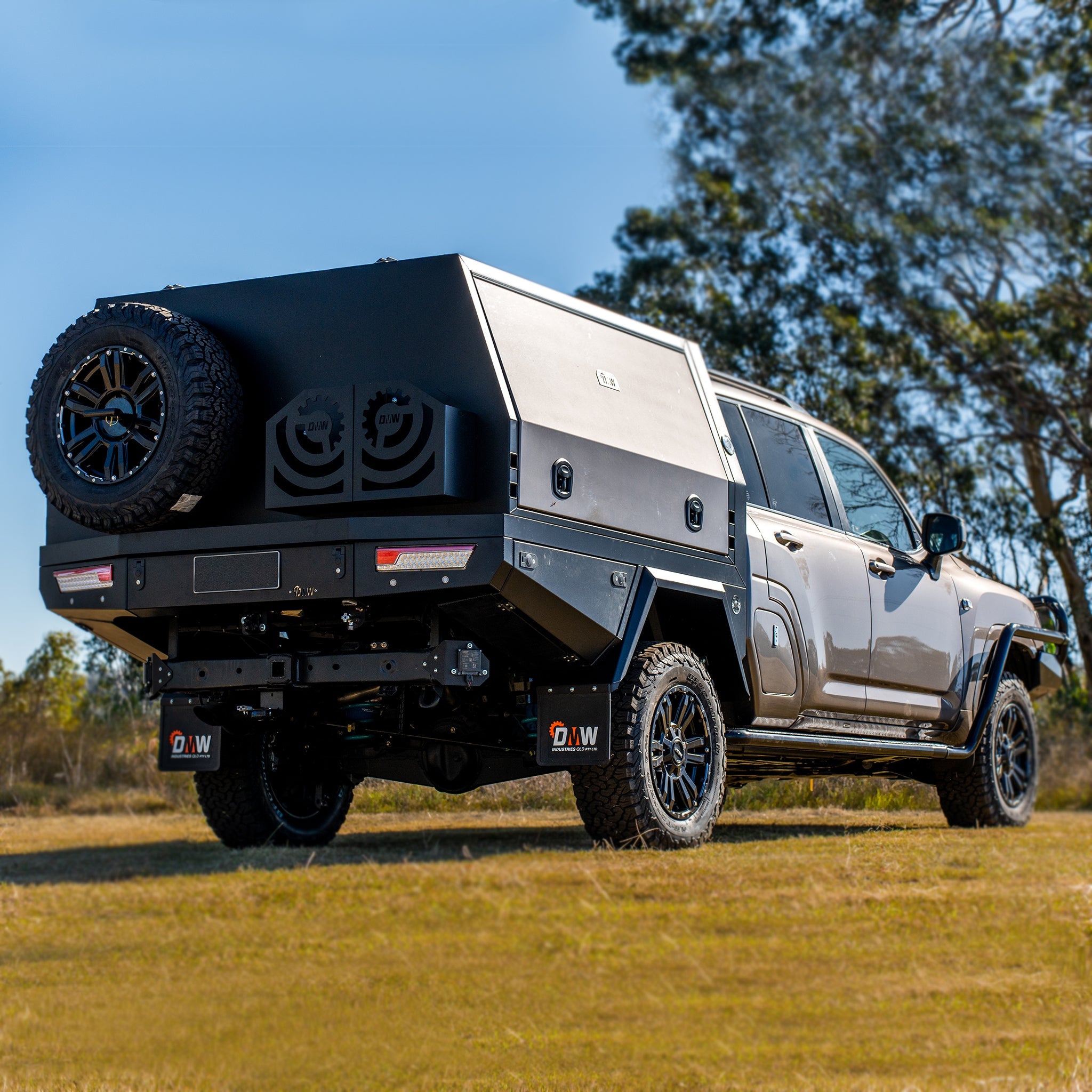 Three-quarter rear view of XTR Aluminium Tray and Canopy on a dual cab 300 Series Land Cruiser Dual Cab, showcasing sleek styling , spare tyre and jerry can storage.
